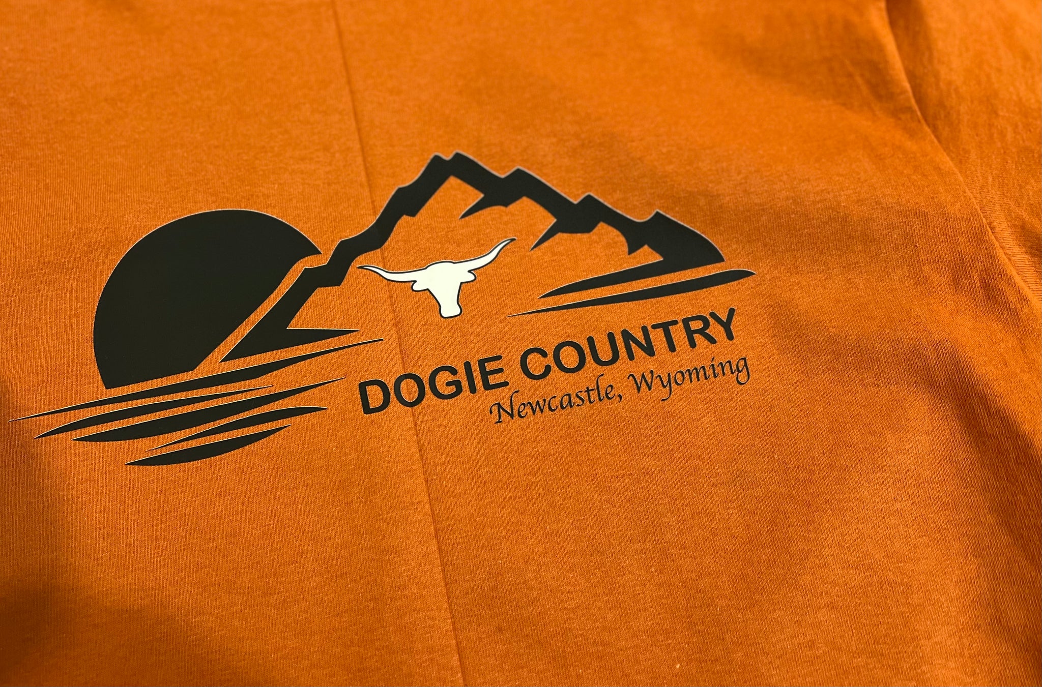 Newcastle Dogie Shirt: Dogie Country on burnt orange